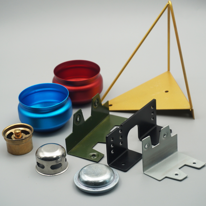 Assorted custom metal parts showing anodized, painted, plated and polished finishes, including brackets, bowls and a brass fitting