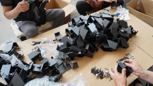 Hands assembling parts at packing table