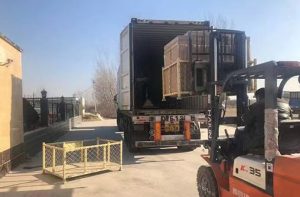 Forklift loading crate into truck