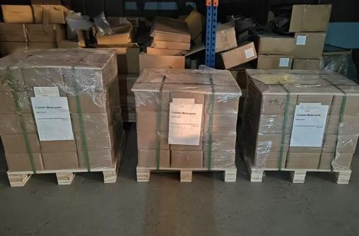 Three export pallets labelled Custom Metal Parts with Made in China marking, shrink-wrapped and strapped for shipment